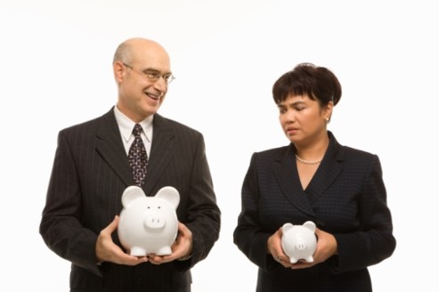 Businesspeople holding piggybanks.